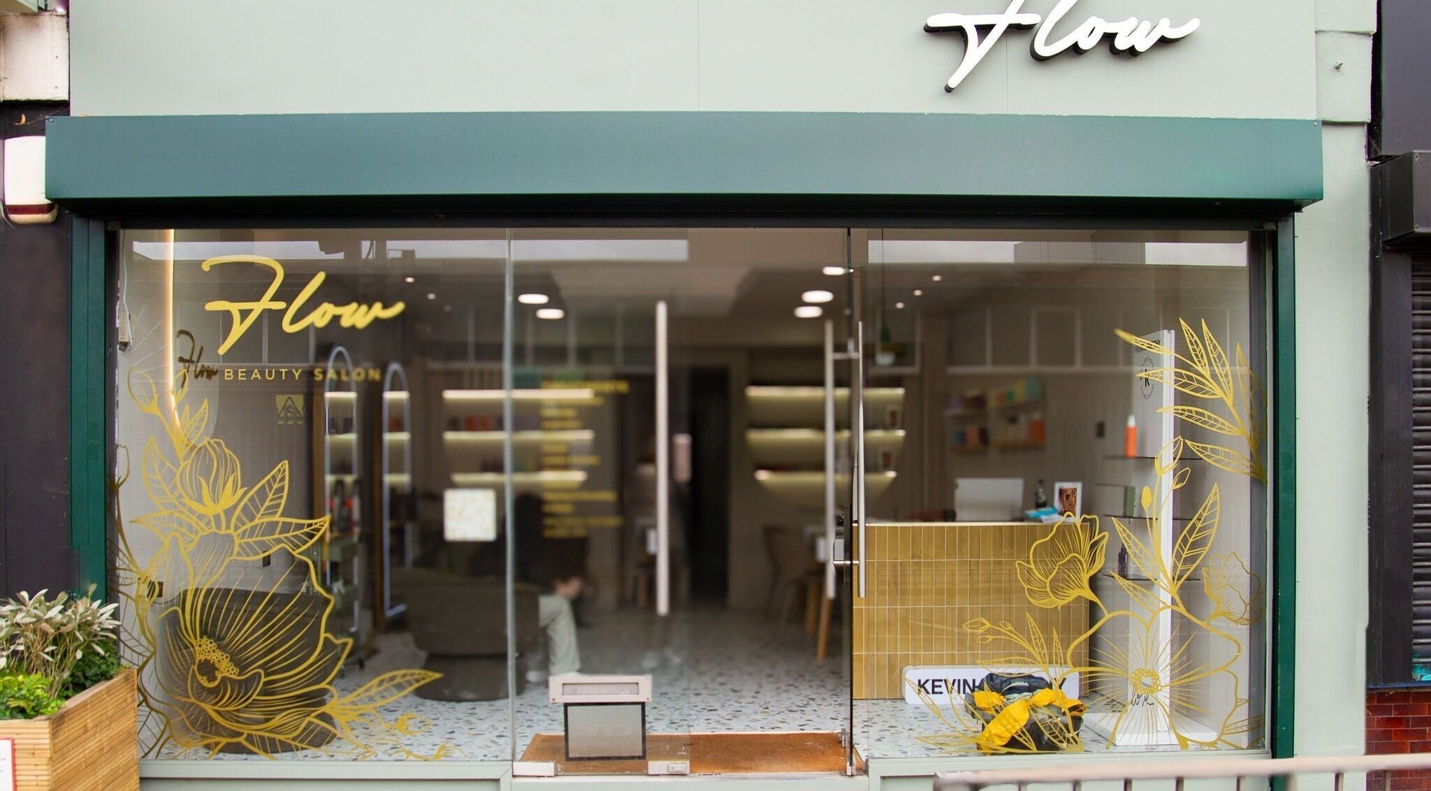 Front view of Flow, a chic beauty salon in London, England, GB, featuring modern floral designs on glass.