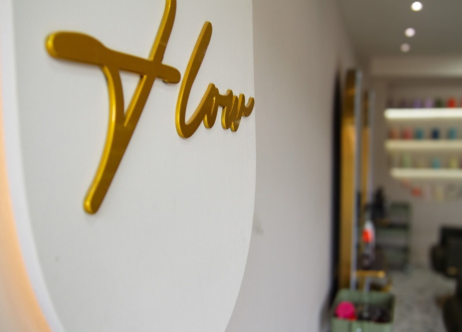 Flow salon sign in gold, capturing modern design at Flow in London, England, GB.