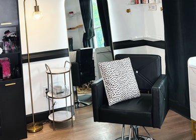 Stylish interior of Eleventh Hour Hair in Gainesville, Georgia, US, showcasing a modern salon chair and decor.