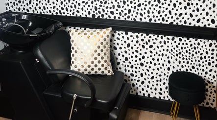 Elegant salon chair and polka dot decor at Eleventh Hour Hair in Gainesville, Georgia, US.