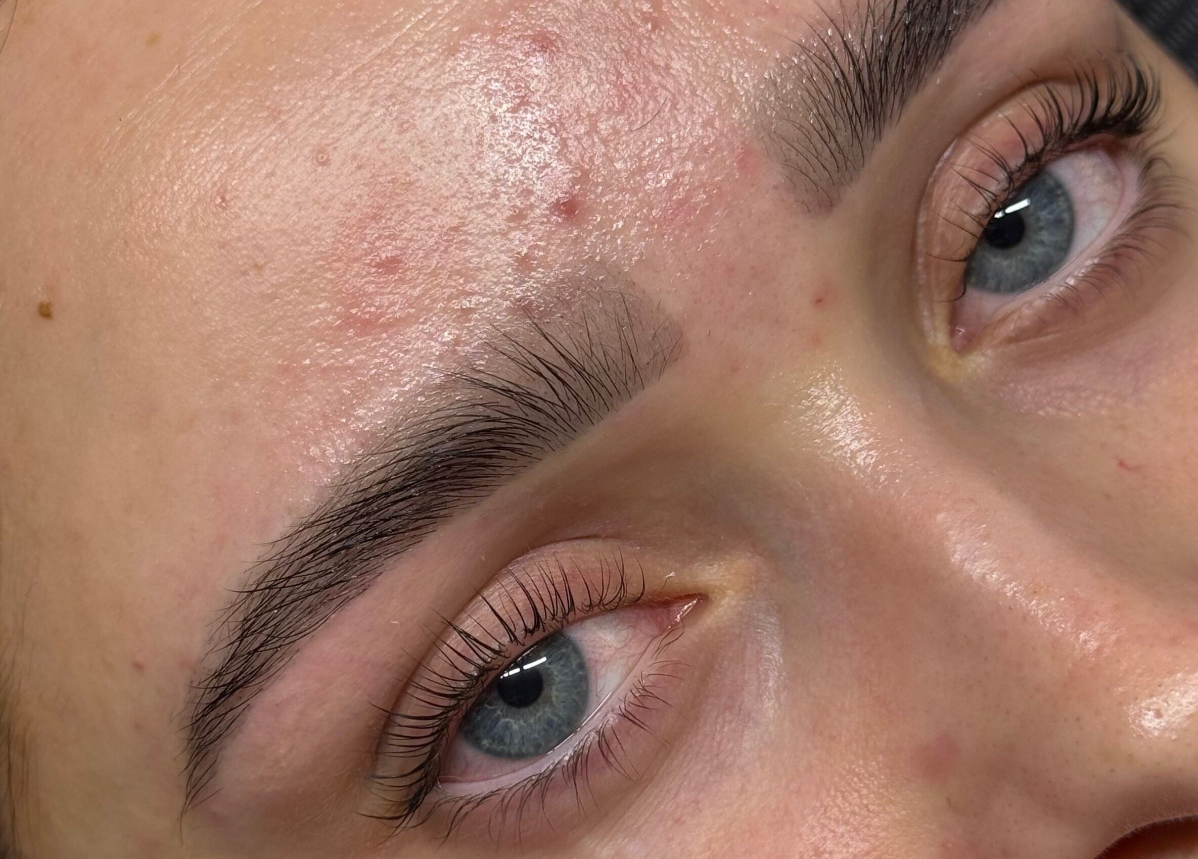 Close-up of well-groomed eyebrows and smooth skin at Studio by MH, Liverpool, England, GB.