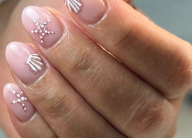 Elegant starry nail art design at Luna Nails, Bradford, England, GB, showcasing intricate pink and white details.