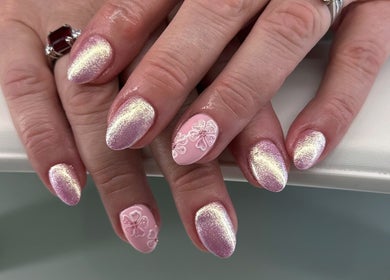 Shimmering pink nails with floral design at Luna Nails, Bradford, England, GB showcasing elegant nail art.
