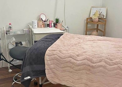 Lash Muse serene treatment room in Broadbeach, Queensland, AU with a cozy bed and soft pink decor.