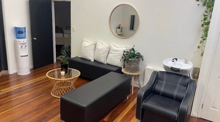 Relaxing lounge area at Lash Muse, Broadbeach, Queensland, AU with sleek seating and chic decor.