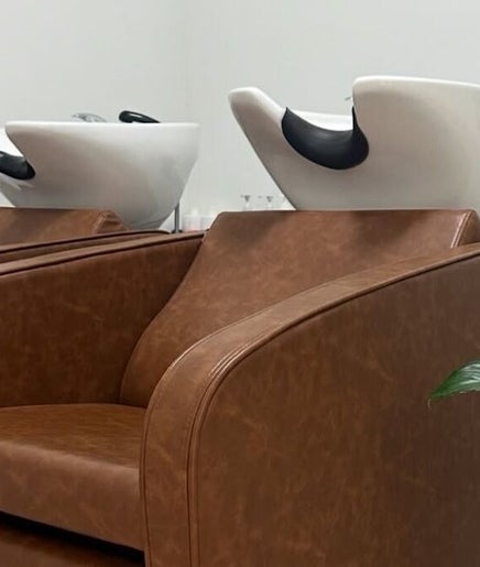 Luxury hair washing stations at VÉRAH in Yeppoon, Queensland, AU, with plush chairs and a sleek interior.