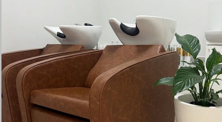 Luxury hair washing stations at VÉRAH in Yeppoon, Queensland, AU, with plush chairs and a sleek interior.