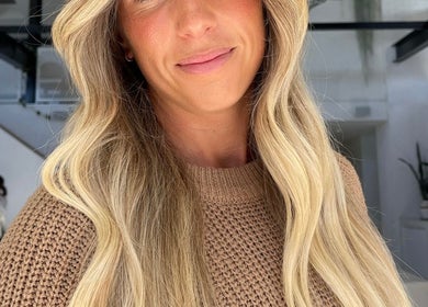 Stylish woman with flowing blonde hair at VÉRAH, Yeppoon, Queensland, AU.