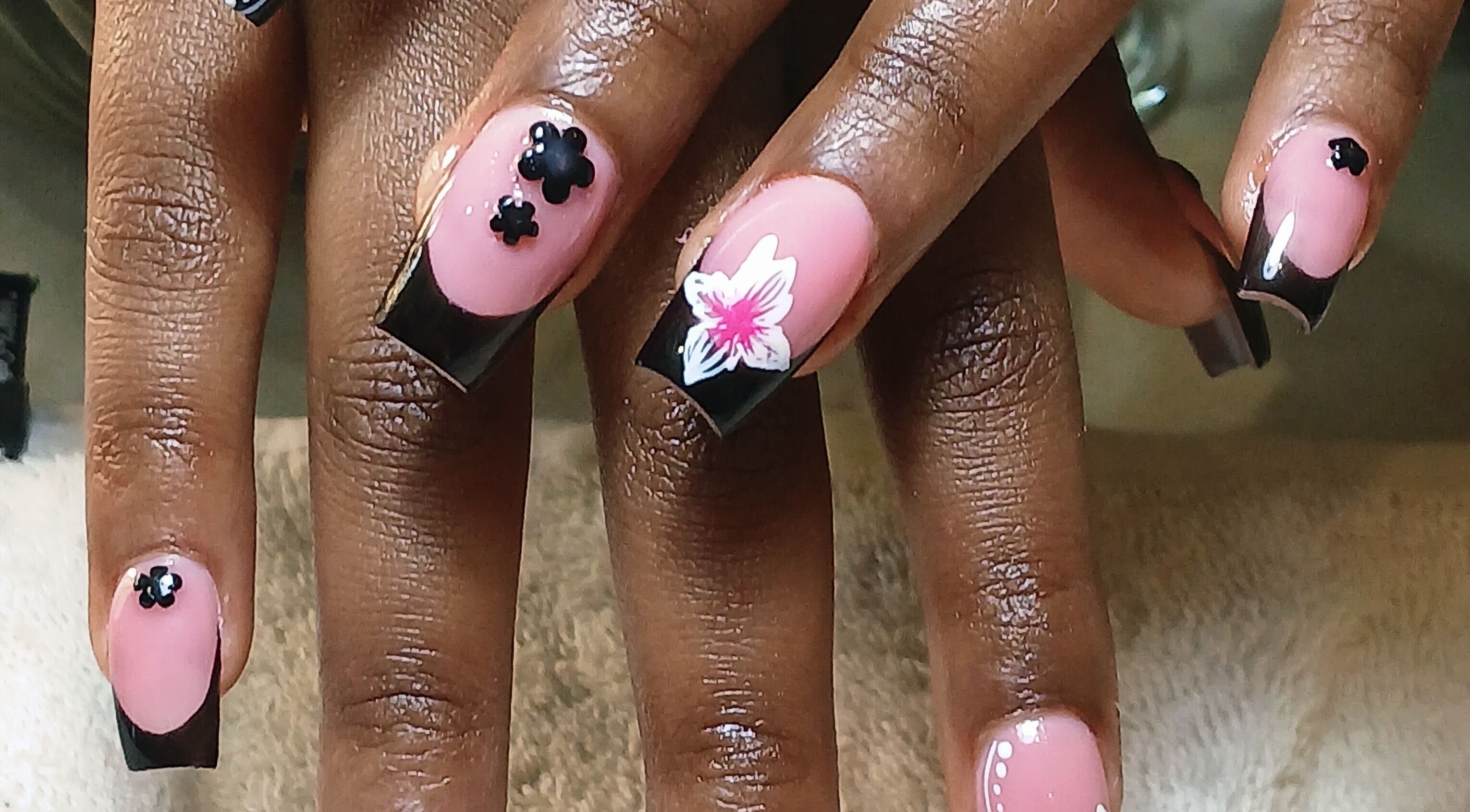 Floral nail art at Alice Beauty Studio, Rustenburg, North West, ZA showcasing elegant black and pink design.
