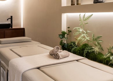 Luxurious spa bed at Gili Head Spa, New York, NY, with earthy decor creating a tranquil atmosphere.