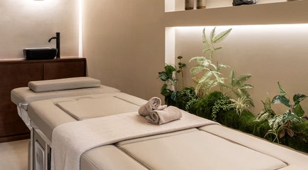 Luxurious spa bed at Gili Head Spa, New York, NY, with earthy decor creating a tranquil atmosphere.