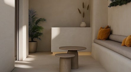 Elegant lobby at Gili Head Spa, New York, featuring minimalist decor with warm tones and lush plants.