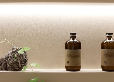 Elegant bottles and plant accent at Gili Head Spa, New York, New York, US, enhancing a tranquil atmosphere.