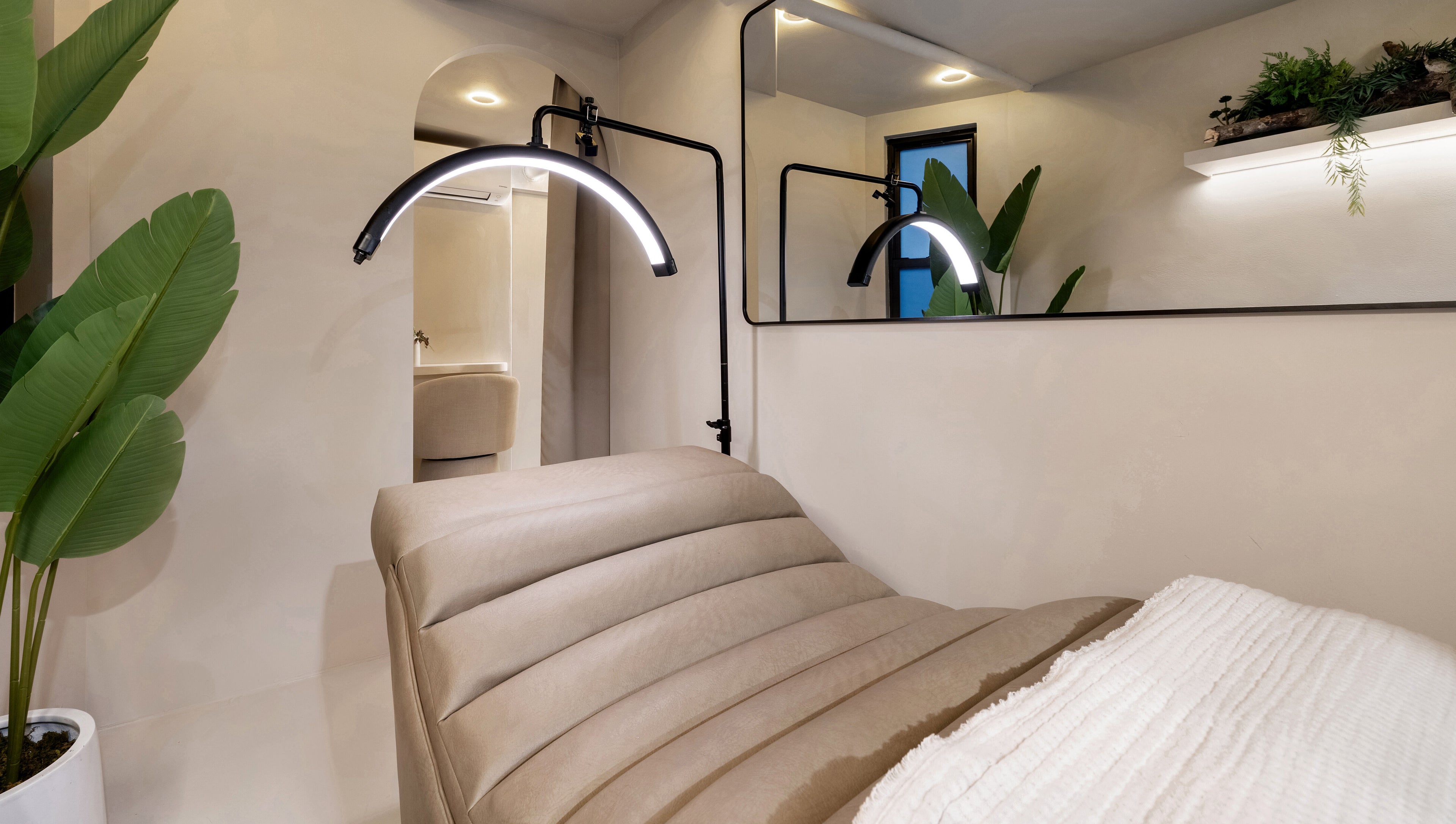 Cozy treatment room at Gili Head Spa, New York, New York, US with ambient lighting and natural decor.