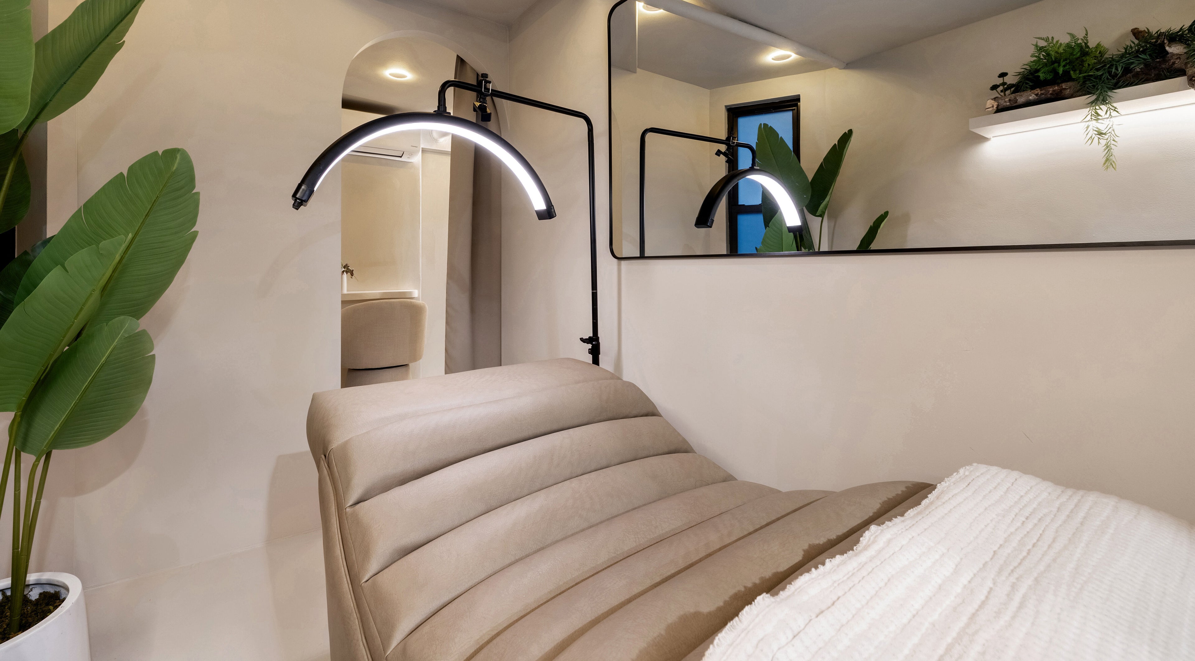 Cozy treatment room at Gili Head Spa, New York, New York, US with ambient lighting and natural decor.