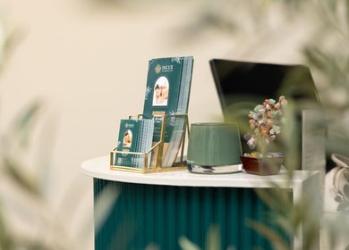 Reception desk at Inlux Thai Massage & Spa, Pukekohe, Auckland, NZ with brochures and a decorative plant.