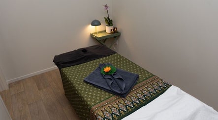Relaxing massage room at INLUX Thai Massage & Spa, Pukekohe, Auckland, NZ with elegant decorated treatment bed.