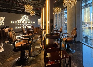 Interior of Kingsmen Barbershop in Dubai, Dubai, AE, showcasing elegant chairs and chandeliers.