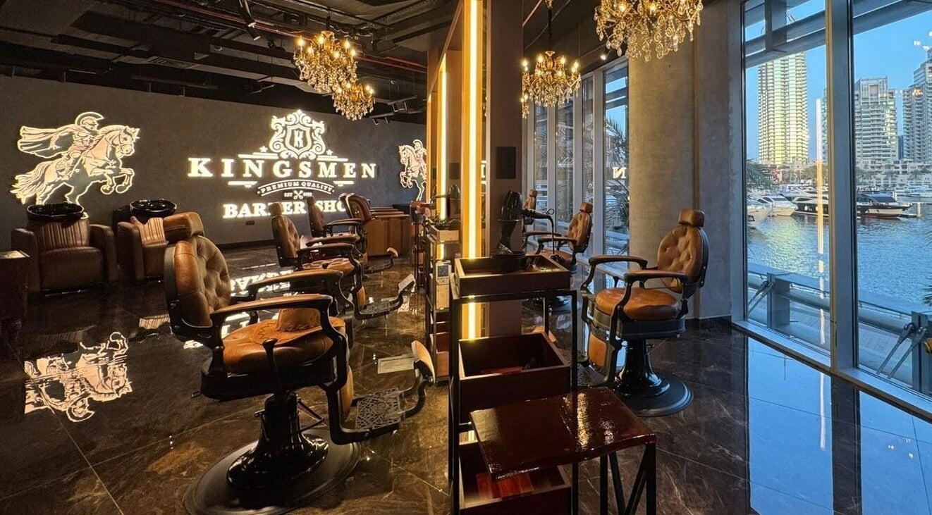 Interior of Kingsmen Barbershop in Dubai, Dubai, AE, showcasing elegant chairs and chandeliers.