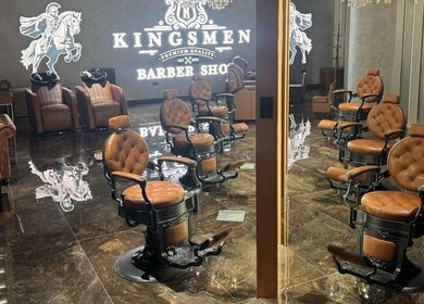 Luxurious interior of Kingsmen Barbershop in Dubai, Dubai, AE with vintage leather chairs and polished floors.