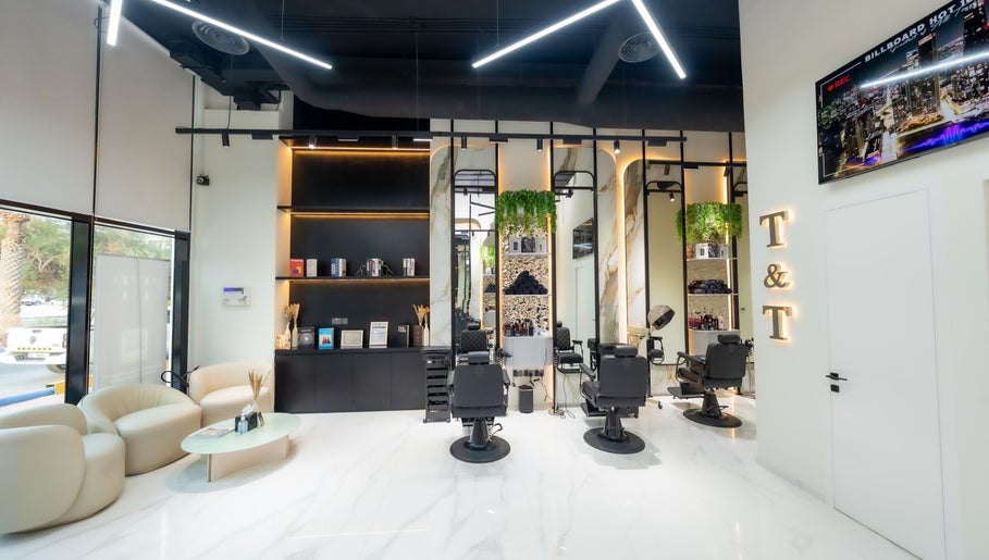 Interior view of Trim & Tame Men Saloon in Dubai, Dubai, AE featuring sleek chairs and stylish decor.