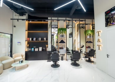 Interior view of Trim & Tame Men Saloon in Dubai, Dubai, AE featuring sleek chairs and stylish decor.