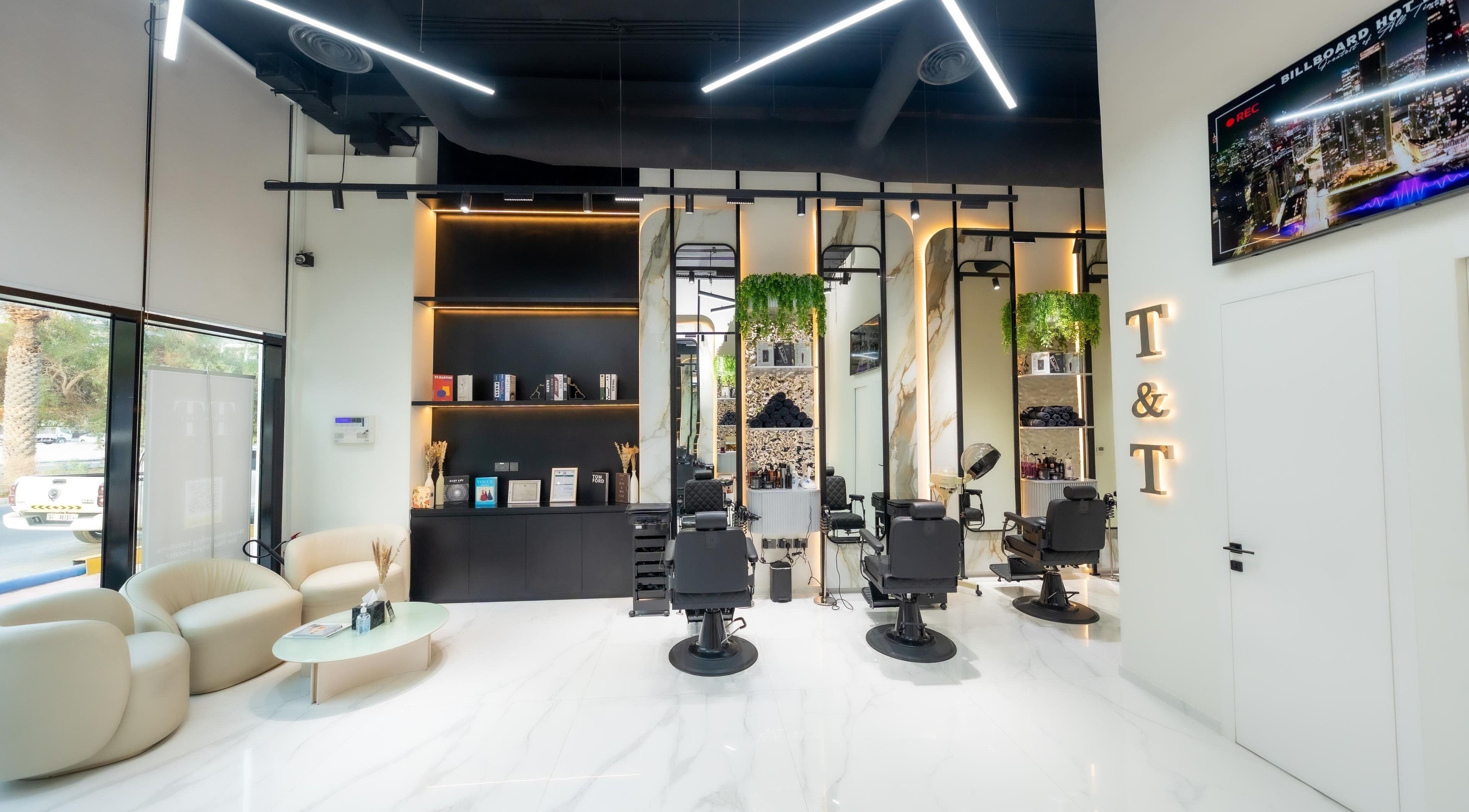 Interior view of Trim & Tame Men Saloon in Dubai, Dubai, AE featuring sleek chairs and stylish decor.