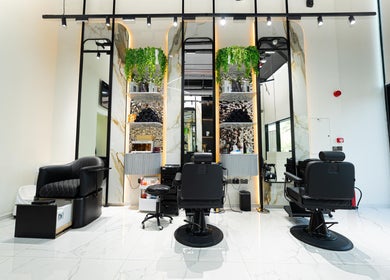 Modern barber chairs at Trim & Tame Men Saloon in Dubai, Dubai, AE, with stylish decor for a luxurious experience.