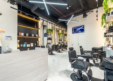 Modern interior of Trim & Tame Men Saloon in Dubai, Dubai, AE with sleek chairs and elegant decor.
