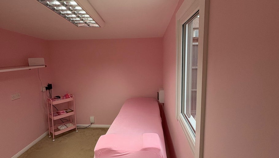 Tranquil pink treatment room at Peachy Lashes By Georgia in Horley, England, GB, perfect for relaxation.