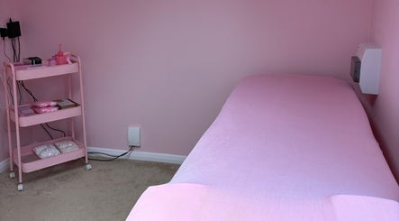 Cozy treatment room at Peachy Lashes By Georgia, Horley, England, GB with pink decor and massage bed.