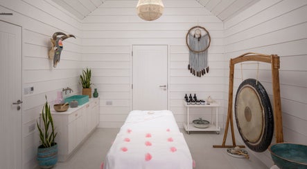 Tranquil spa room at Relax at Three Mile Beach, Gwithian, England, GB, featuring a massage table and decor.