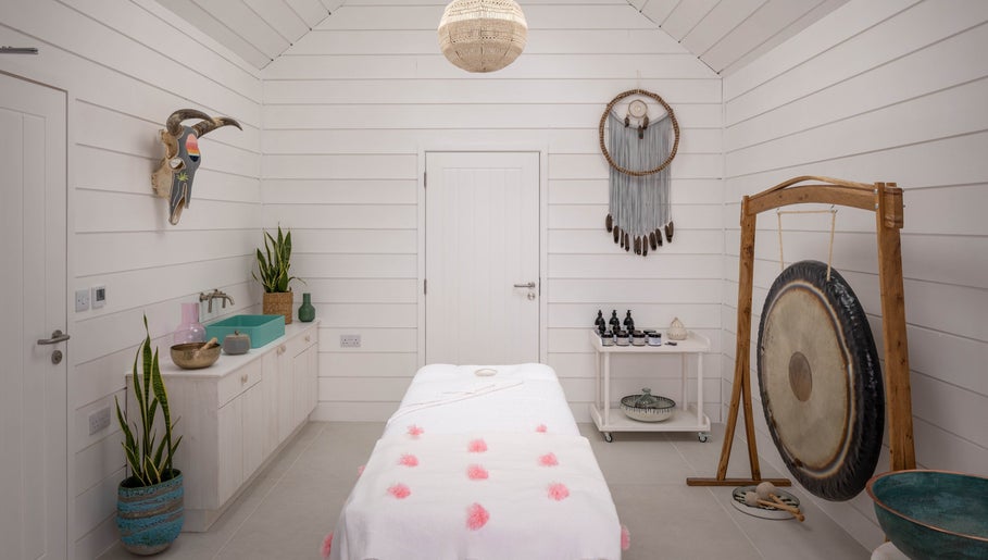 Calming spa room at Relax at Three Mile Beach, Gwithian, England, GB, featuring a massage table and soothing decor.
