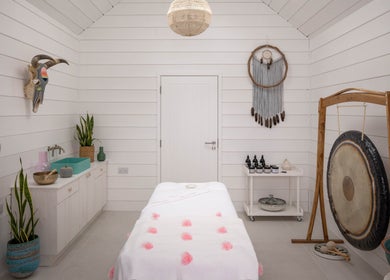 Calming spa room at Relax at Three Mile Beach, Gwithian, England, GB, featuring a massage table and soothing decor.