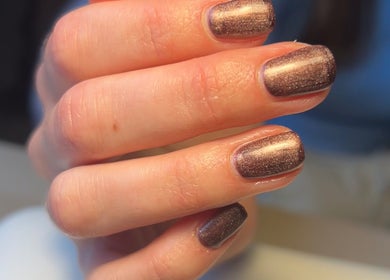 Elegant bronze manicure at Nails By Kate, Stamford Bridge, England, GB, showcasing shimmering nail art.