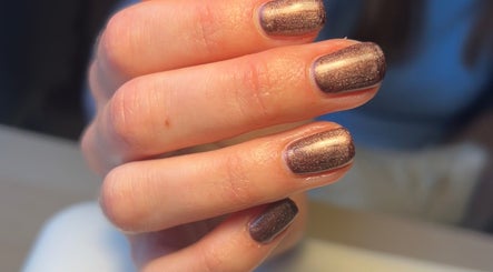 Elegant bronze manicure at Nails By Kate, Stamford Bridge, England, GB, showcasing shimmering nail art.