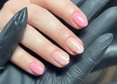 Close-up of floral nail art at SF LASER in Dereham, England, GB. Pink gel nails with delicate designs.