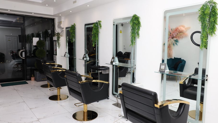 Chic interior of Dlux Beauty, London, England, GB with modern salon chairs and mirrors.