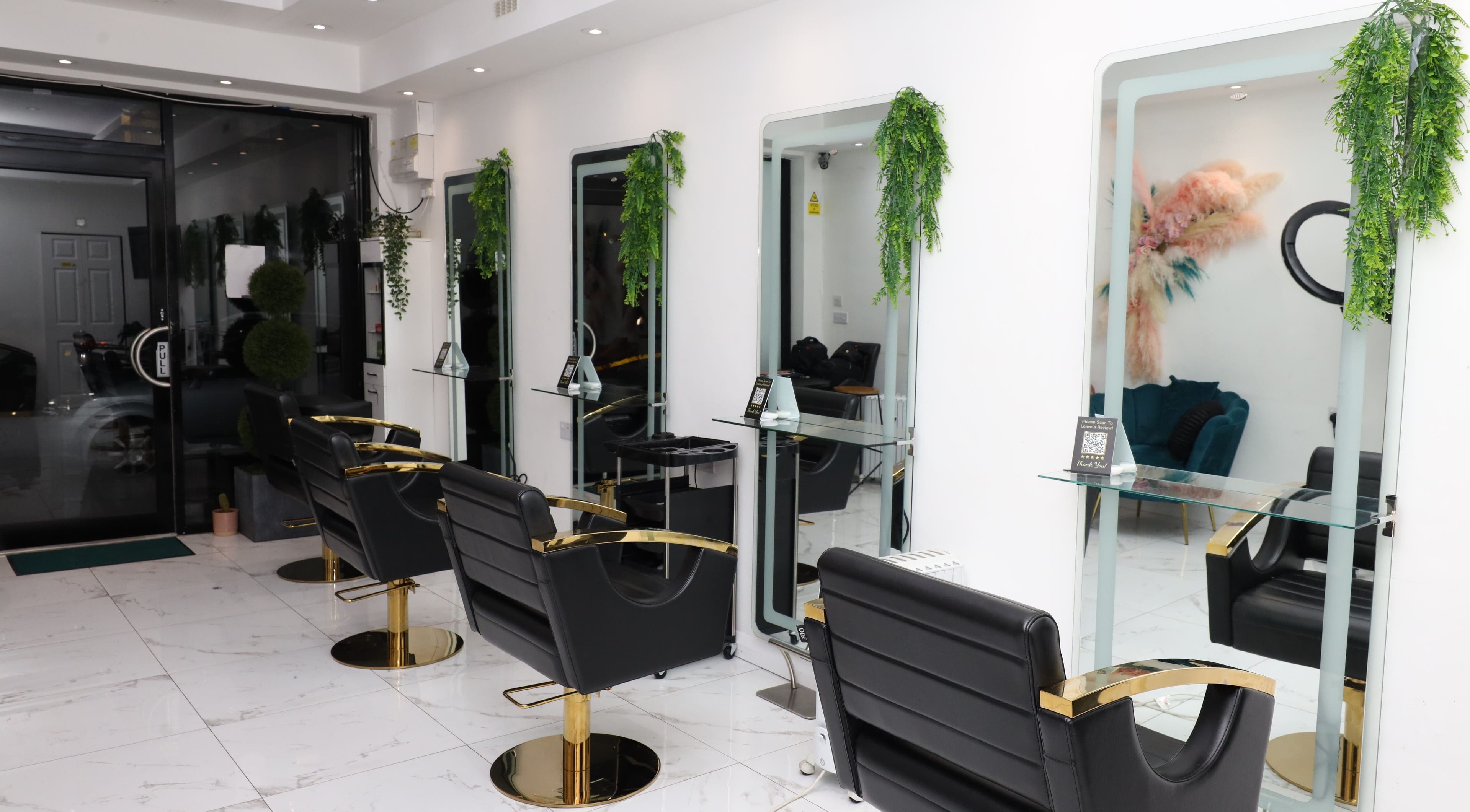 Chic interior of Dlux Beauty, London, England, GB with modern salon chairs and mirrors.