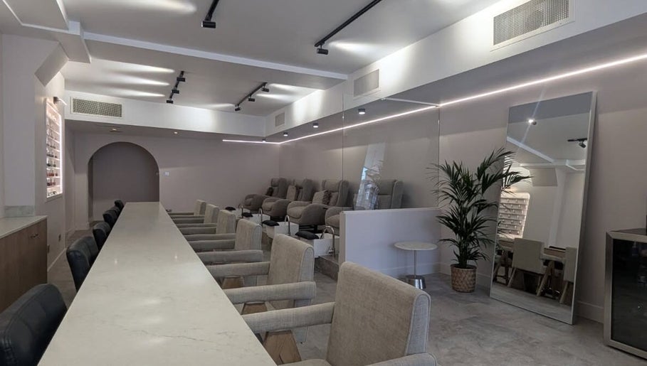 Elegant interior of néutra beauty lounge in London, England, GB featuring plush seating and modern decor.