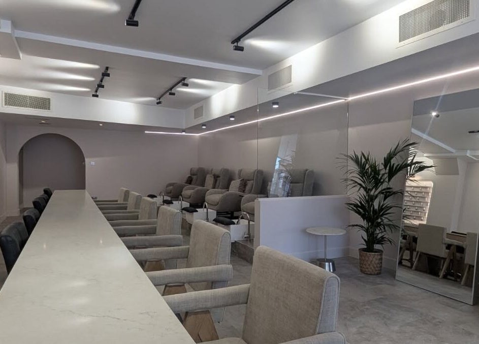 Elegant interior of néutra beauty lounge in London, England, GB featuring plush seating and modern decor.