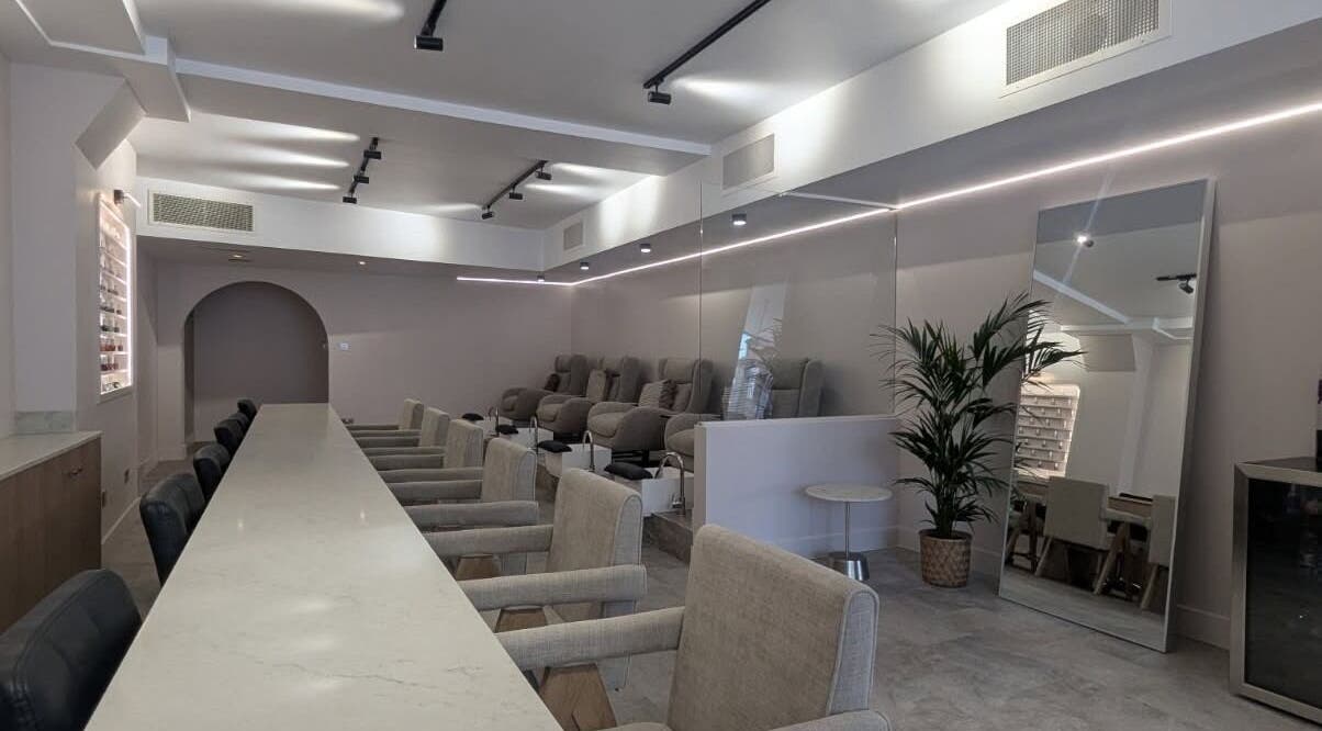 Elegant interior of néutra beauty lounge in London, England, GB featuring plush seating and modern decor.