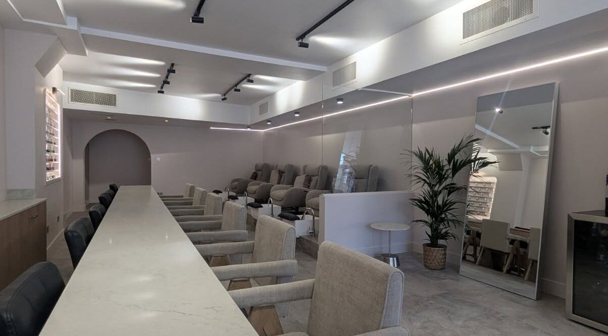 Elegant interior of néutra beauty lounge in London, England, GB featuring plush seating and modern decor.