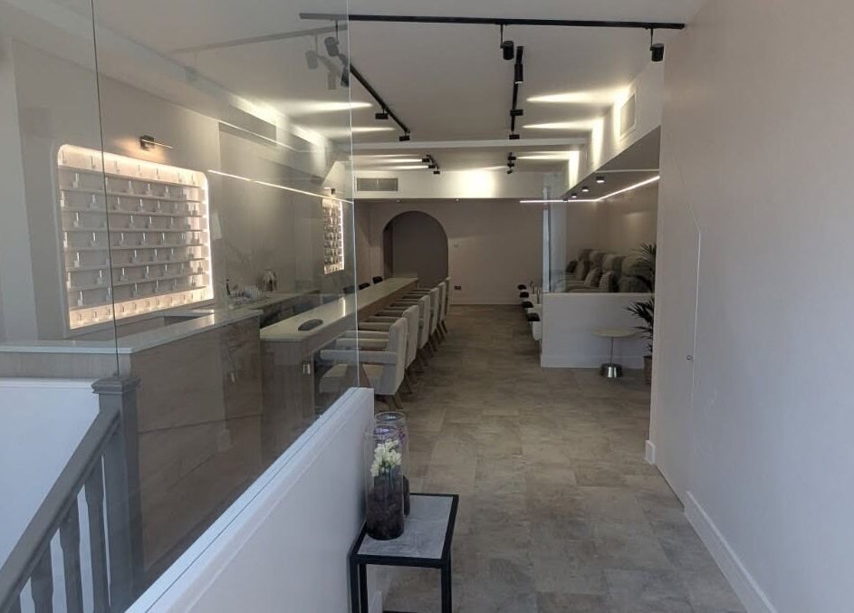Modern, elegant interior of néutra beauty salon in London, England, GB with plush seating and ambient lighting.