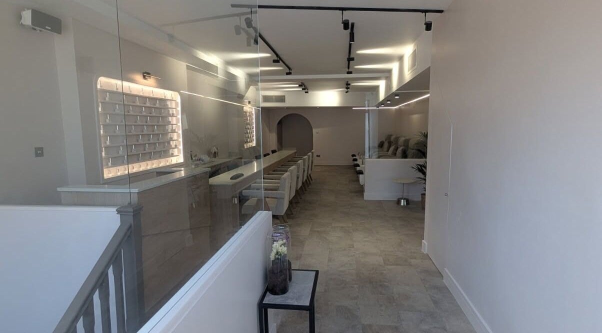 Modern, elegant interior of néutra beauty salon in London, England, GB with plush seating and ambient lighting.