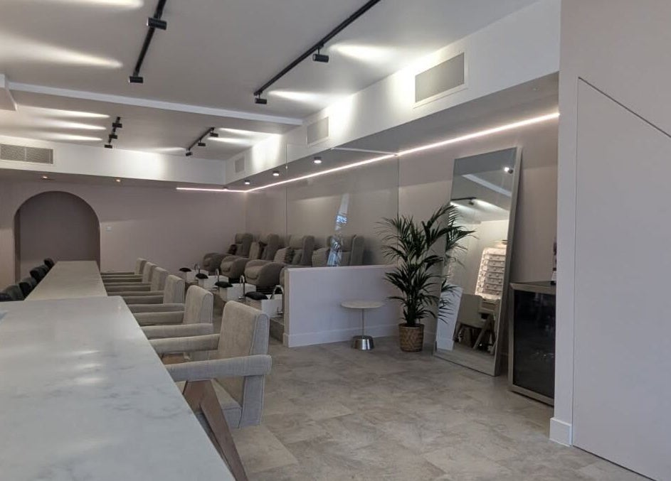 Modern salon interior at néutra, London, England, GB, featuring elegant seating and soft lighting.
