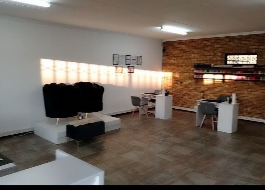 Spacious interior of Bare& Polished salon in Westonaria, Gauteng, ZA with modern and inviting nail stations.