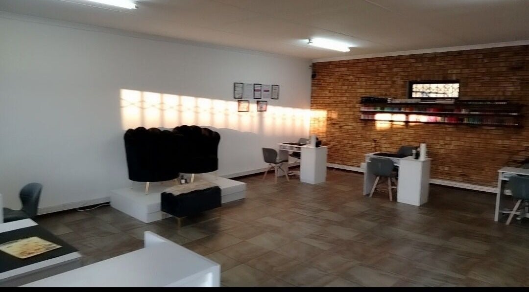 Spacious interior of Bare& Polished salon in Westonaria, Gauteng, ZA with modern and inviting nail stations.