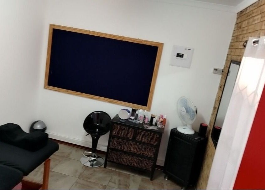 Relaxing treatment room at Bare& Polished in Westonaria, Gauteng, ZA featuring a massage bed and chic decor.