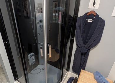 Luxurious steam shower and robe at J. Madison Spa, Kingston, PA, US for ultimate relaxation.